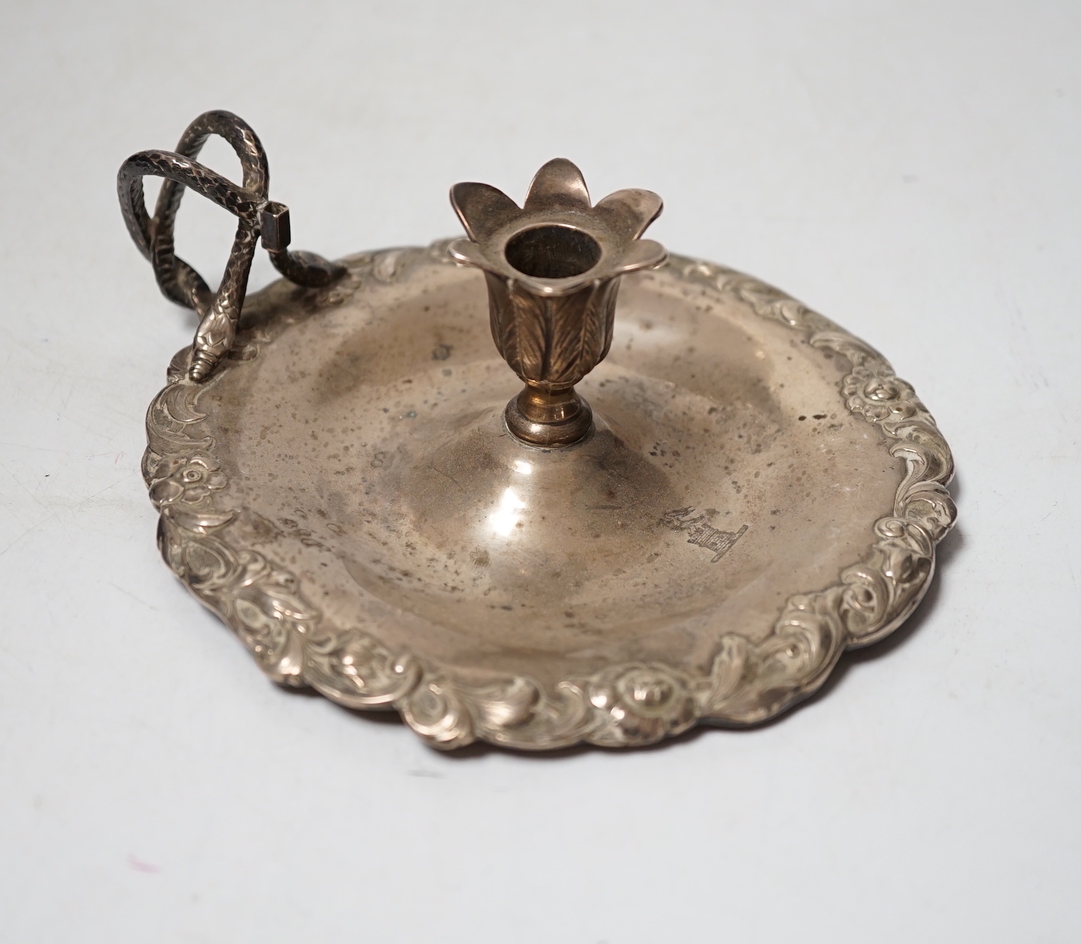 An early Victorian silver chamberstick, Robert Hennell III, London, 1842, with foliate border, 13.8cm, lacking snuffer, 5.9oz.